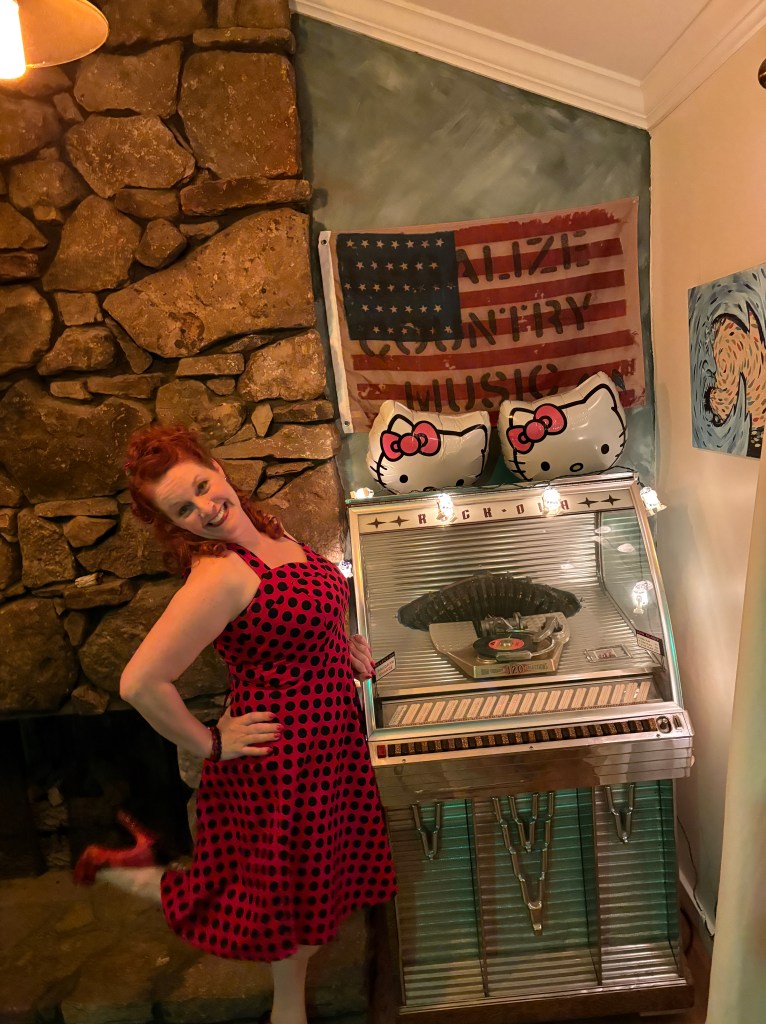 jamie kristen jukebox red dress with black polka dots hand on hip fun pose